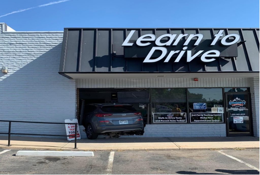 Rookie driving instructor crashes through shop window on first day